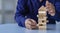 risk management concepts Hands trying to protect the crumbling wooden blocks block tower businessman