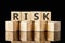RISK text assembled from wooden cubes on a black background