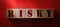 Risky word on wooden blocks on red background. Risky assets, financial risk in business investment concept. Dangeruos virus