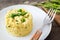 Risotto with asparagus, parsley and peas on a rustic wooden table