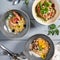 Risotto and noodles in ceramic bowls top view