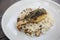 risotto with sea bass fillet steak on a plate , italian food