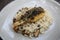 Risotto with sea bass fillet steak on wooden table , italian food