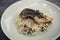 Risotto with sea bass fillet steak on wooden table , italian food