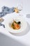 Risotto with seafood in contemporary style on white background. Italian risotto with prawn, mussels, squid in frutti di mare style