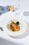 Risotto with seafood in contemporary style on white background. Italian risotto with prawn, mussels, squid in frutti di mare style