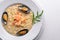 Risotto with seafood, shrimp, mussels and squids and cheese. On a wooden background.