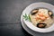 Risotto with seafood, shrimp, mussels and squids and cheese. On a wooden background.