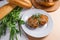 Rissole of pork served on a white plate with white wheat bread a