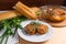 Rissole of pork served on a white plate with white wheat bread a