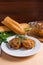 Rissole of pork served on a white plate with white wheat bread a