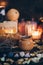 A ritual halloween witchcraft scene with candles, herbs, vintage bottles on the rustic background