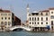 Riva degli Schiavoni waterfront at the Pieta Bridge Ponte de la Pieta with a leaning bell-tower in the background, Venice