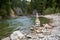 A river in the Alps in Bavaria with a large cairn on the river bank