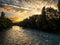 River Arve, Switzerland, in deep shadow as the sky is illuminated by the rising sun.