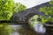 River Balvag with old arched stone bridge