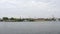 River bank with dock and vessels. View from sailing ship