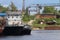 River bay with rusty cargo ships on sunny day