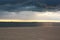 River beach and dark waters of river at sunset