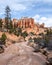 River bed leading to other worldly looking hoodoos under blue skies in Bryce Canyon National Park.