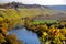 River bend with great autumn colors on the bank and in the vineyard