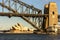 River beneath Sydney harbour bridge that links north and south sydney city with opera building in background. All basked in good