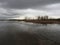 River in Biesbosch National Park under a gloomy and cloudy sky