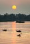 River boats,silhouetted at sunset,in the beautiful 4000 Islands, Mekong River,Don Det,southern Laos.Southeast Asia