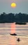 River boats,silhouetted at sunset,in the beautiful 4000 Islands, Mekong River,Don Det,southern Laos.Southeast Asia