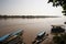 River Boats tied up to pier alon river bank with view to other shore in Puerto Maldonado in Peru and the Amazon
