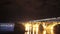 River bridge at night, cars drive water flows, clouds time-lapse