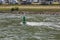 A river buoy, a floating sign of navigation equipment on the Rhine River against the background of resting tourists