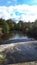 The River Calder from the bridge across it in Padiham own Centre.  This river powered 20 cotton weaving Mills in 1906,all