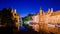 River canal and medieval houses at night, Bruges