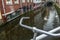 River canal and street with bicycle parking lot in Dutch Delft old city