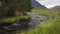 A river of clean water coming down from the high mountains of the green Glencoe Valley, Highlands, Scotland.