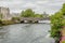 River Corrib with its flowing waters, the William O`Brien bridge and the green dome of the cathedral in the background