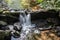 River course littered with rocks with waterfall