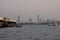 A river cruise ship floats on the Chao Phraya River. Modern skyscrapers on the river bank