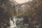 River through dam to emerald pool surrounding by cliff forest