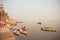 River dock area with riverboats at evening on sacred river Ganges