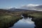 A river at the edge of Wild Nephin National Park in Ireland. Snow on the mountains.