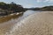 River estuary across the beach meeting the South Pacific Ocean in Marion Bay