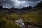 River in the Fairy Pools on the Isle of Skye under a stormy sky, Scotland, United Kingdom