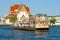 River ferry against the backdrop of a Buddhist temple Wat Rakhang Khositaram Ubosot, Bangkok