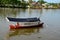 River ferry with boatman steers boat to landing jetty pier across Sarawak River Kuching Malaysia