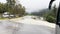 River Flooding Spills onto Road Near Briksdal Valley, Norway