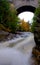 River Flowing Under Historic Arched Stone Bridge Acadia National