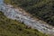 River Flowing Through Winter Vegetation Lined Valley