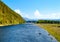 River flows among hills and forests